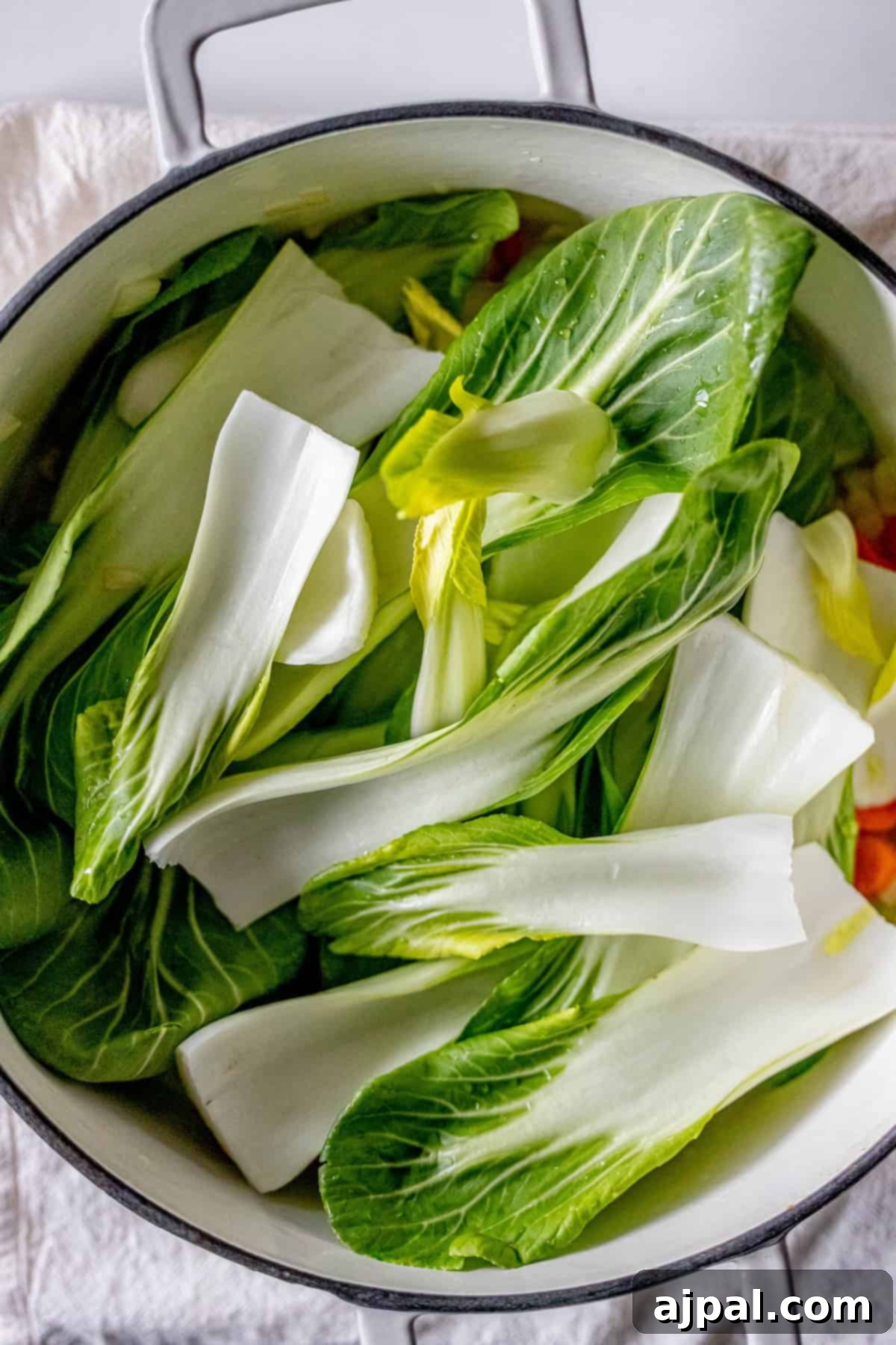 Easy 15-Minute One-Pot Potsticker Soup 8 A pot filled with chopped bok choy leaves, the perfect base for a quick and delicious 15-minute potsticker soup.