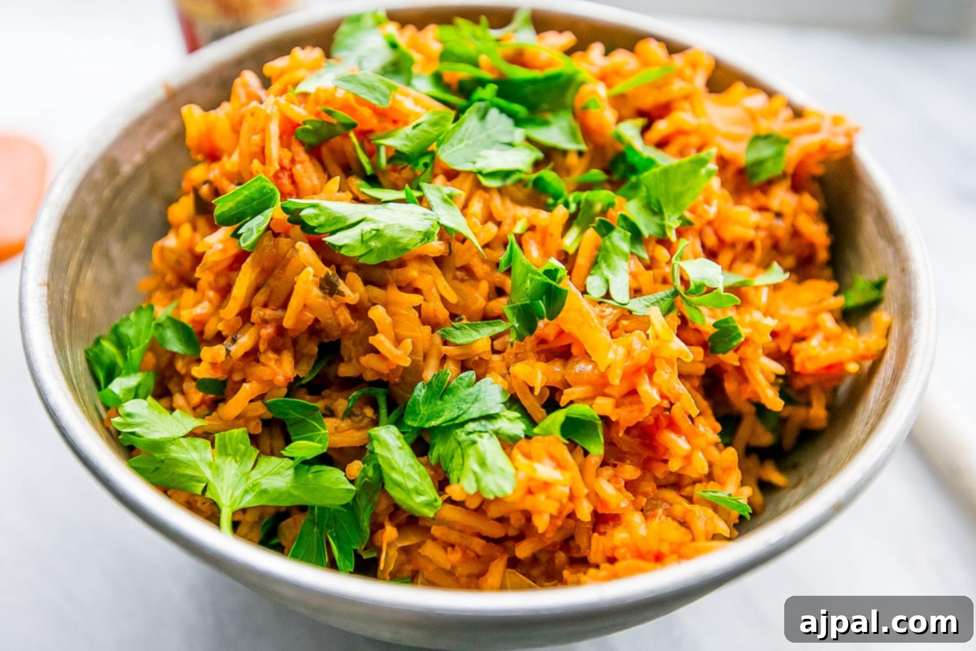A vibrant, spicy Portuguese-inspired rice side dish, garnished with fresh cilantro and parsley, ready to be enjoyed.