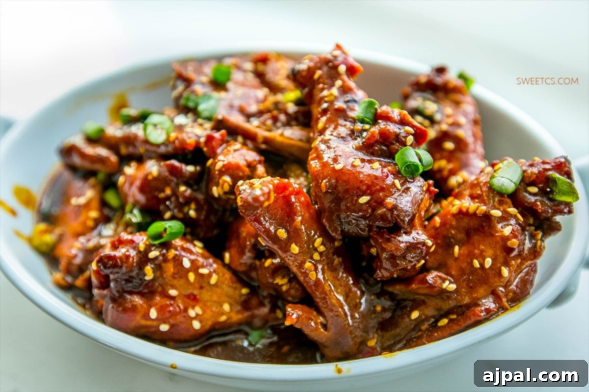 Sticky Honey Soy Slow Cooker Chicken Wings 6 Easy chicken wings with a sticky honey soy sauce, garnished with green onions.