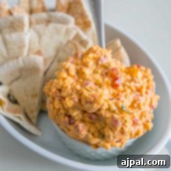 Irresistible Pimiento Cheese Dip 6 Pimiento cheese dip served with pita chips.