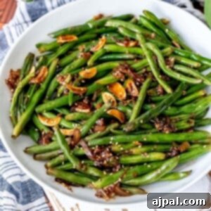 picture of chinese garlic green beans in a white bowl on a table