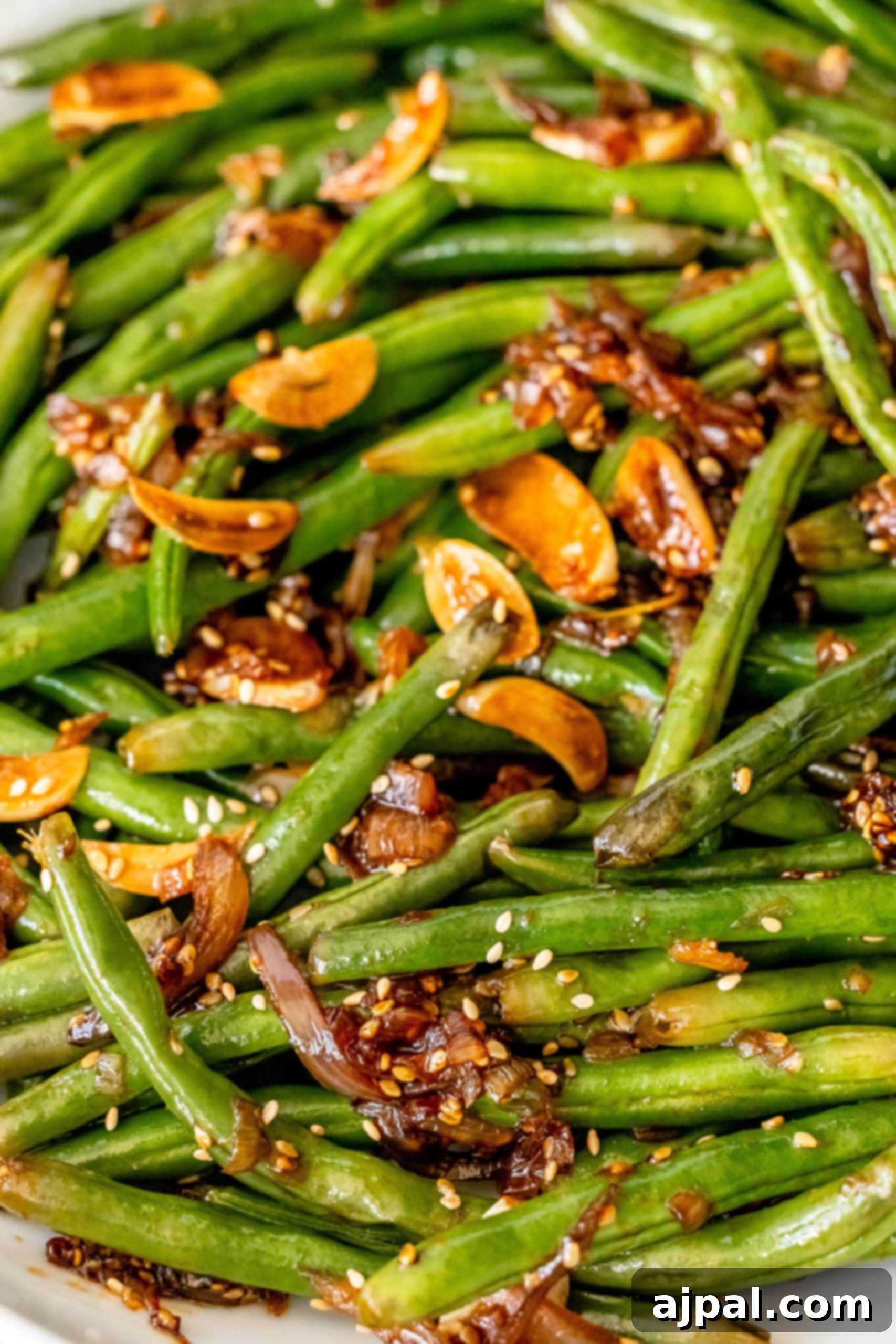 Chinese style green beans with sesame seeds on a plate.