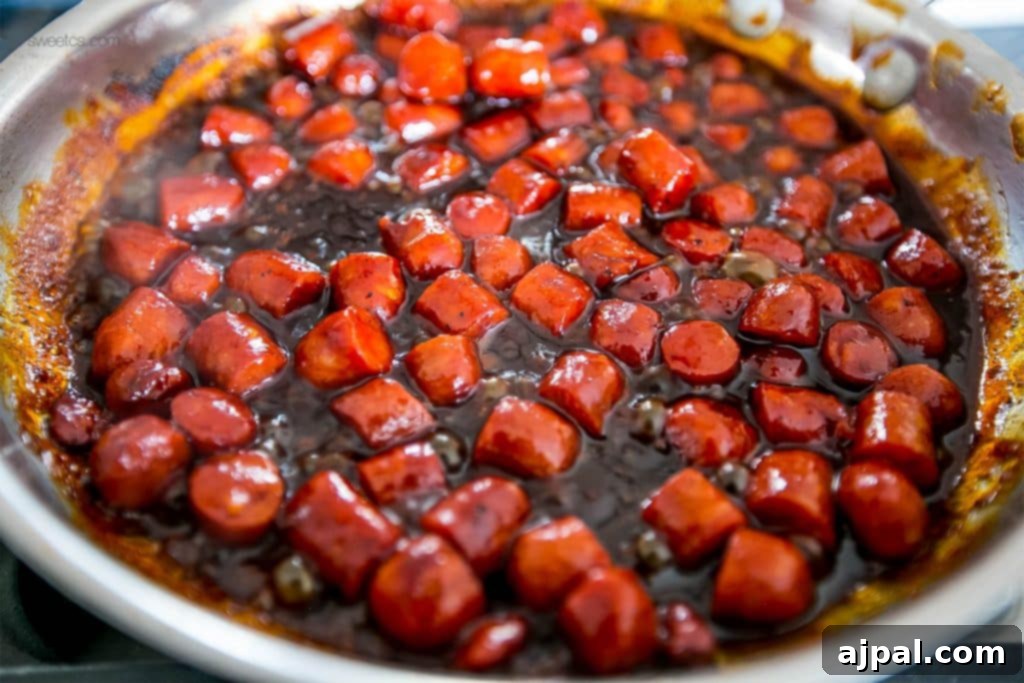 Hearty Cheesy BBQ Smokie Bake 5 little smokies sausages in bbq sauce in a pan
