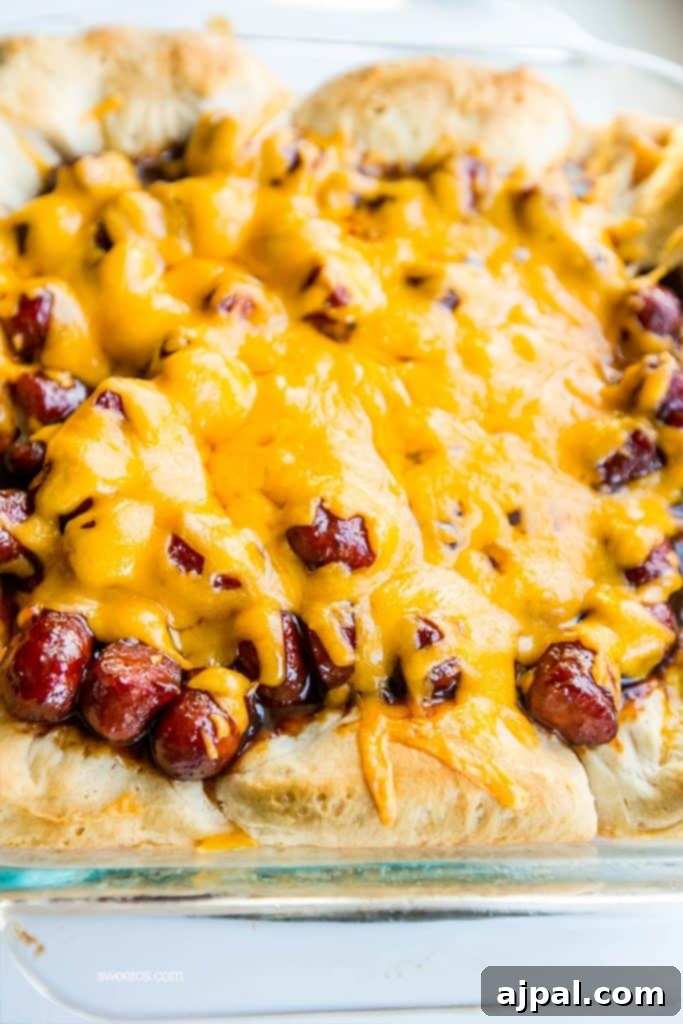 Hearty Cheesy BBQ Smokie Bake 6 biscuits with bbq sauce and little smokies sausages and cheese on them