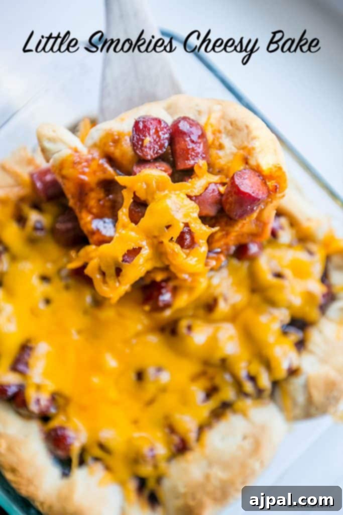 Hearty Cheesy BBQ Smokie Bake 7 wooden spoon lifting biscuits with little smokies sausages and cheese on them