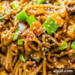 Creamy tahini noodles with vegetables and sesame seeds.