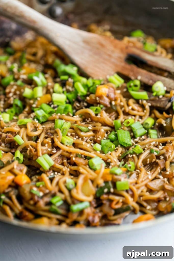 Velvety Tahini Noodles 8 A large skillet filled with creamy vegan tahini noodles and a vibrant mix of sautéed vegetables, ready to be served.