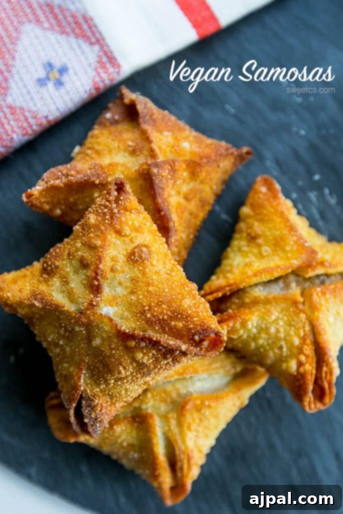 Kickin' Vegan Samosas 6 Spicy vegan samosas beautifully plated and served with a napkin, ready for enjoyment.
