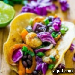 Roasted habanero tomatillo shrimp tacos on a wooden cutting board, ready to serve.