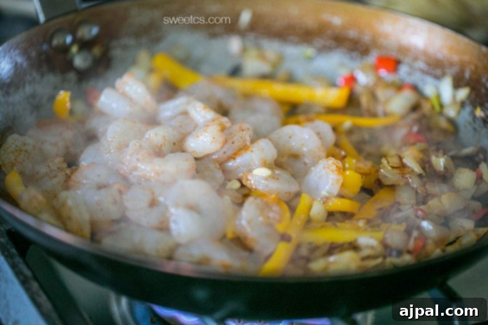Zesty Old Bay Shrimp Fajita Tacos 5 Shrimp and vegetables in a wok cooked with Old Bay seasoning.