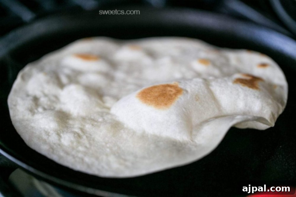 A fajita tortilla is being cooked in a skillet on the stove.