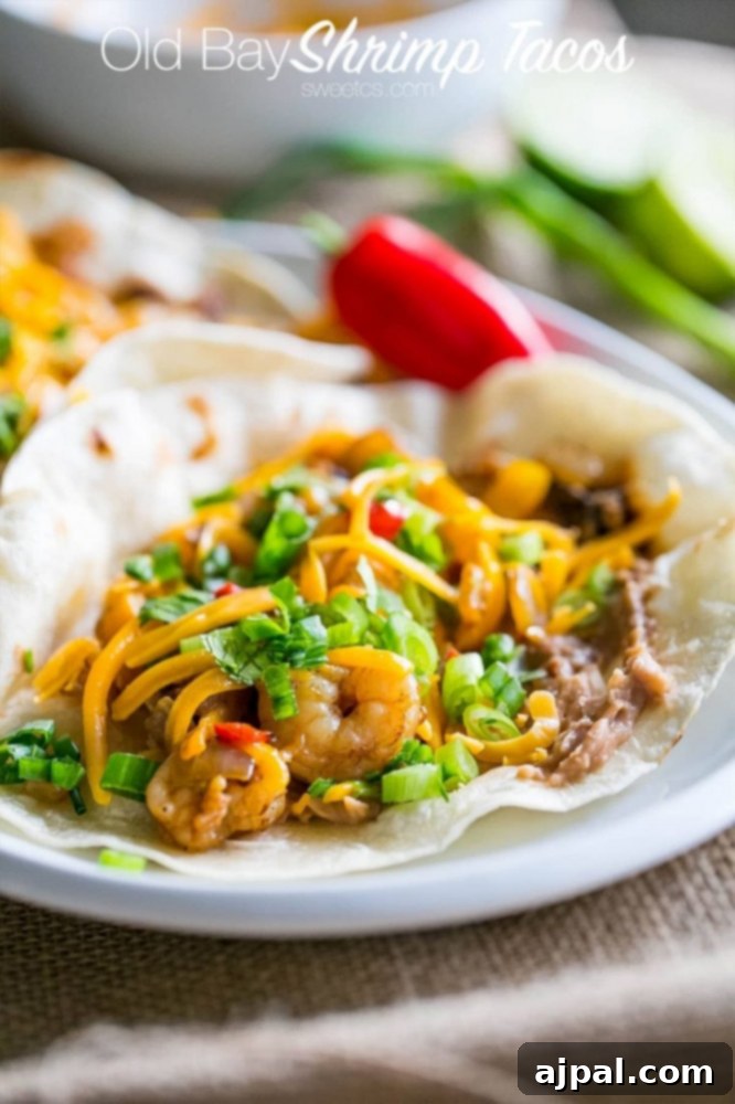 Zesty Old Bay Shrimp Fajita Tacos 7 Old Bay shrimp fajita tacos on a plate.