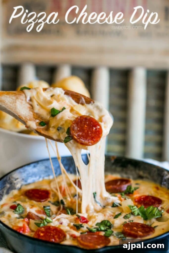 Picture of spoon dipping into pepperoni pizza cheese dip