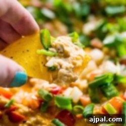 Cheesy chicken enchilada dip made in a skillet.