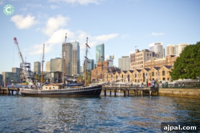 Best Travel Credit Cards for Your Next Adventure 3 Sydney's iconic Circular Quay with a boat docked in the harbor and tall city buildings in the background.