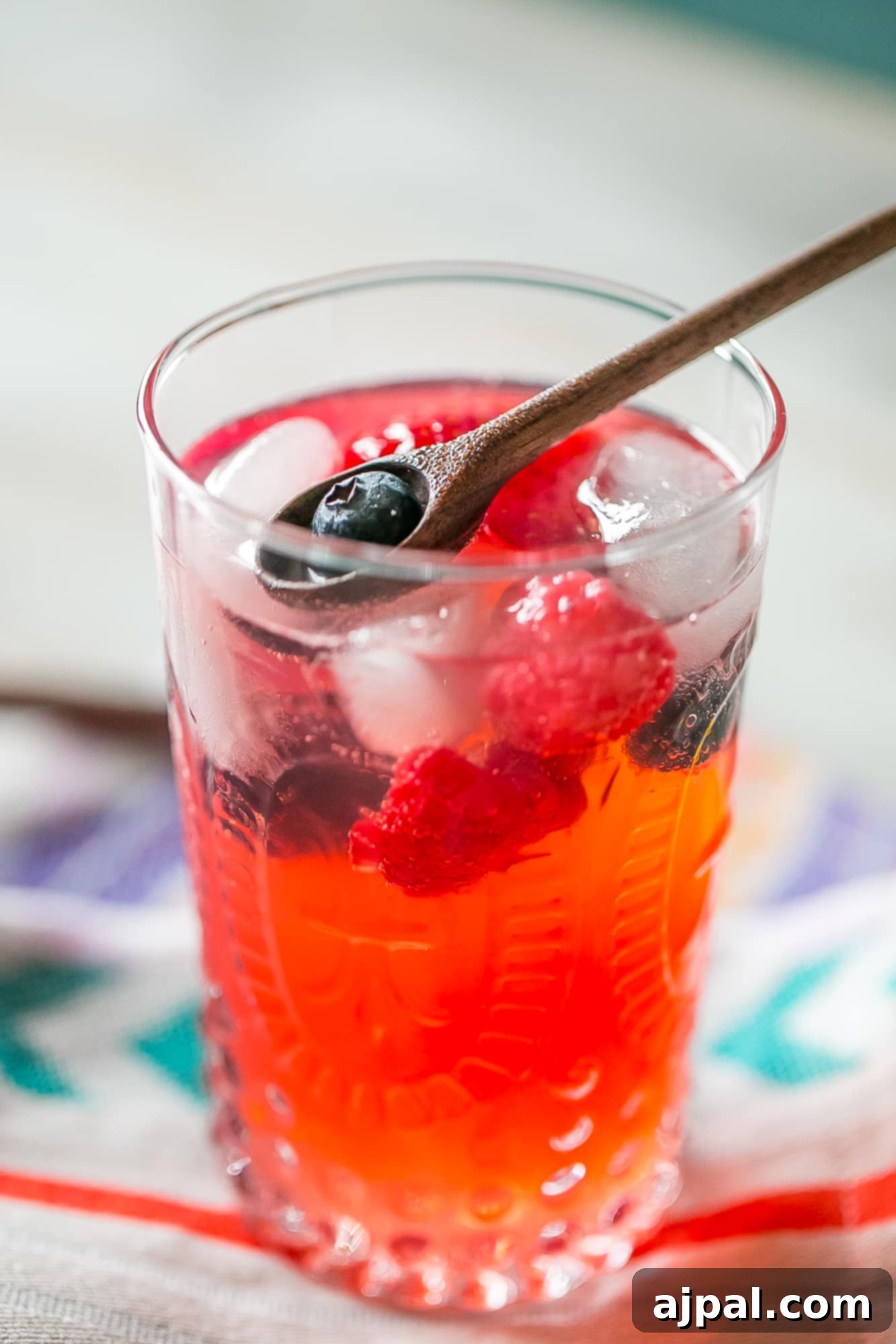 Berry Basil Garden Sparkler 4 An array of fresh ingredients for sparkling lemonade: basil leaves, lemons, and mixed berries, vibrant and ready for preparation.