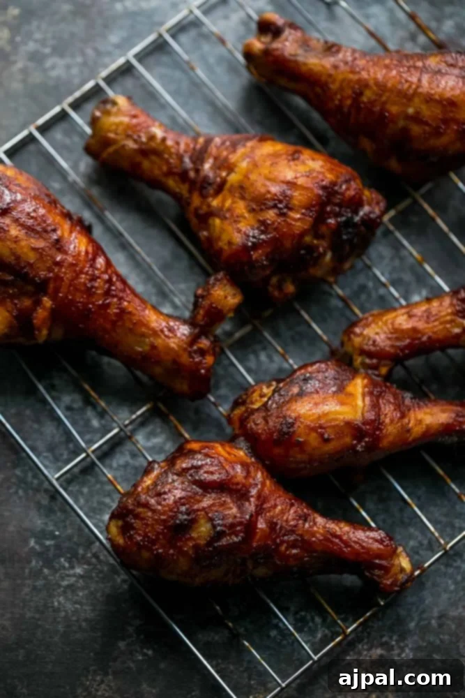 Crispy BBQ Chicken Drumsticks 11 Picture of baked bbq chicken drumsticks on wire rack, golden and delicious