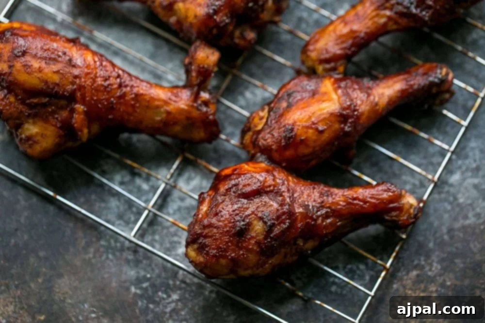 Crispy BBQ Chicken Drumsticks 4 Picture of baked bbq chicken legs on wire rack, perfectly golden brown