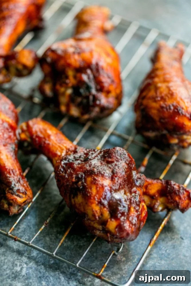 Crispy BBQ Chicken Drumsticks 8 Picture of baked bbq chicken drumsticks on wire rack, with vibrant BBQ glaze