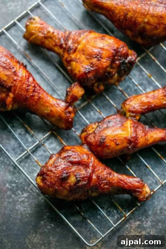Crispy BBQ Chicken Drumsticks 10 Picture of baked bbq chicken drumsticks on wire rack, glistening and ready to serve