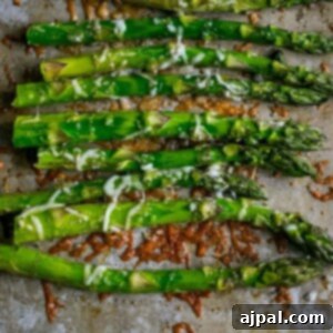 asparagus roasted on a baking sheet with parmesan and garlic