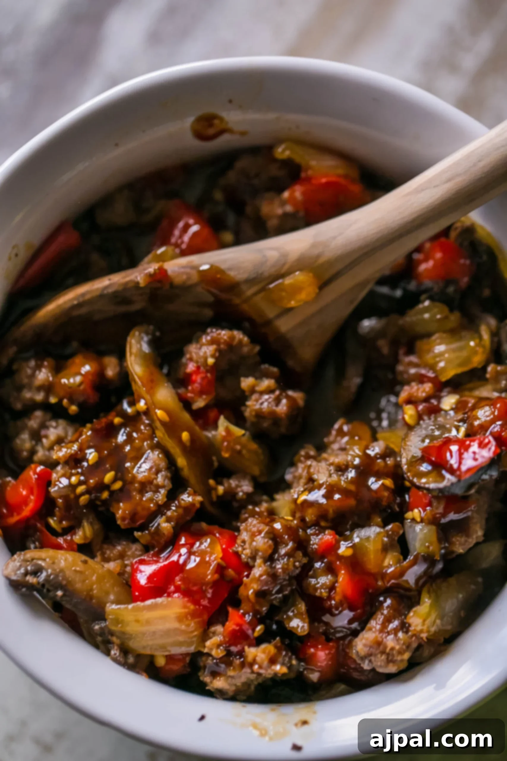 A bowl filled with rich, savory sweet chili beef and tender mushrooms, ready to be served.