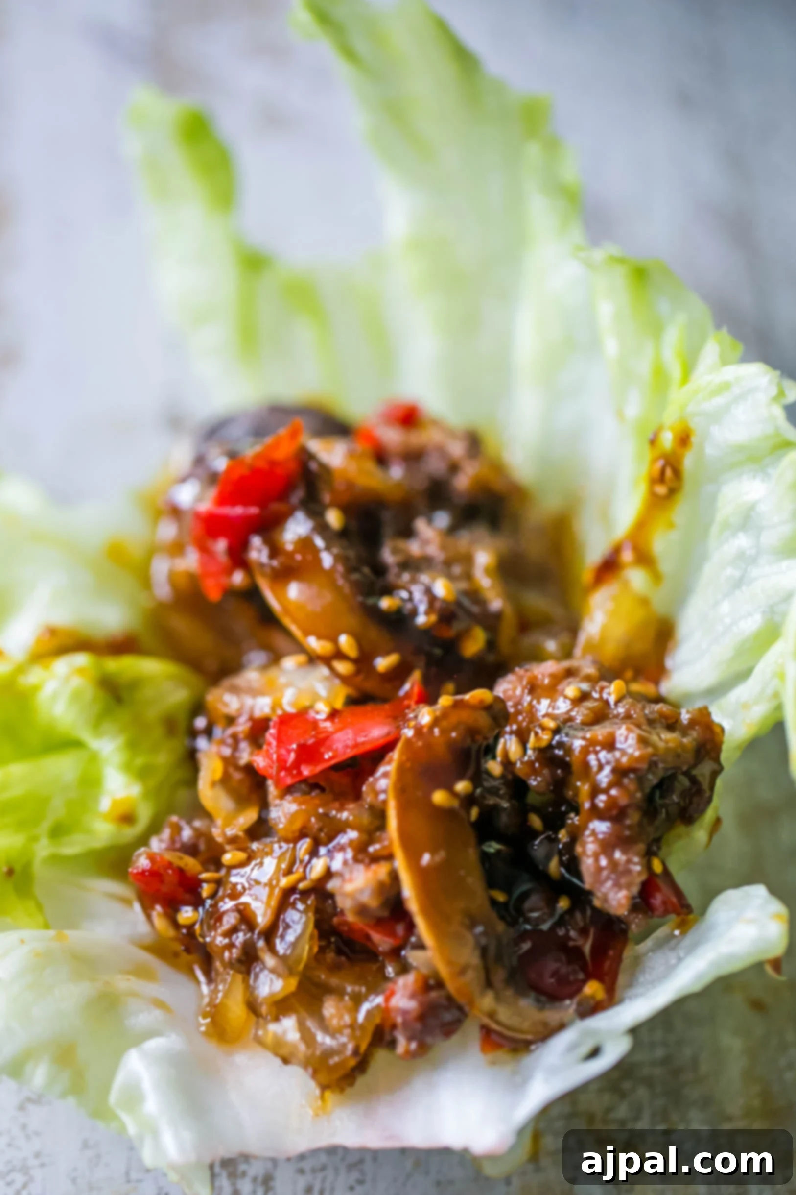 A fresh lettuce wrap filled with sweet chili beef and vegetables, ready to be enjoyed.