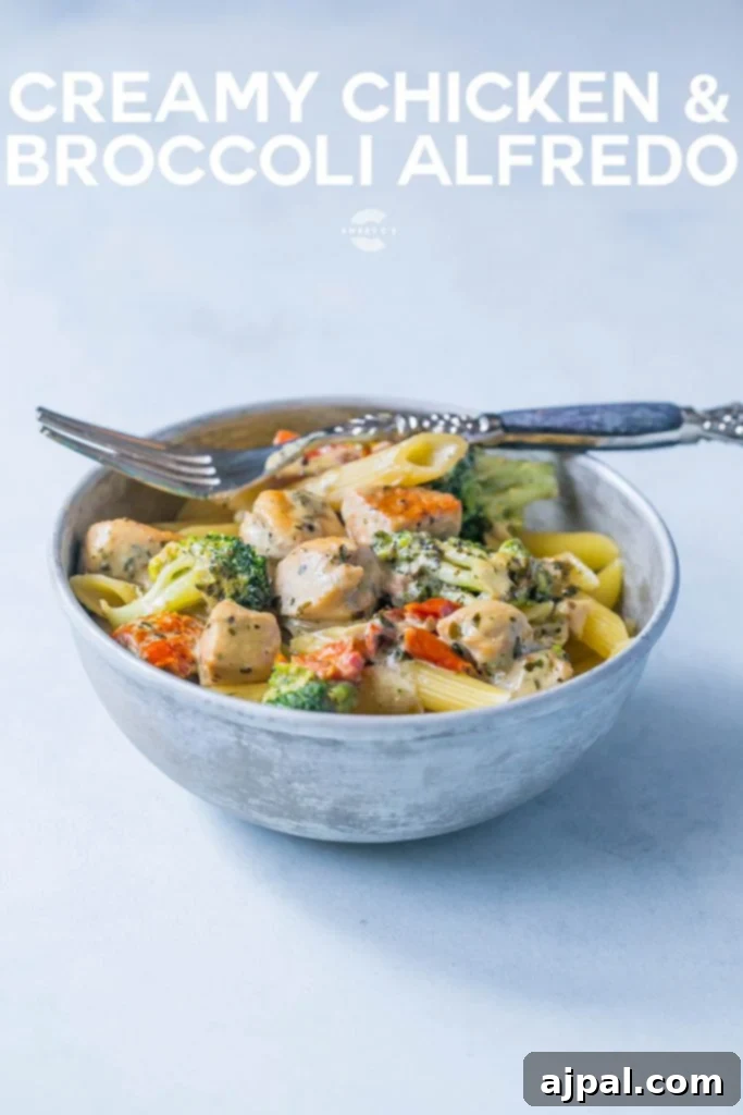 Creamy chicken and broccoli alfredo in  bowl with a fork