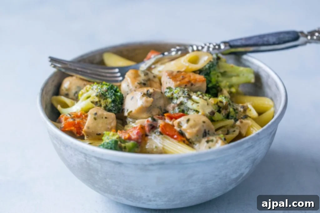 Creamy chicken and broccoli alfredo in  bowl with a fork