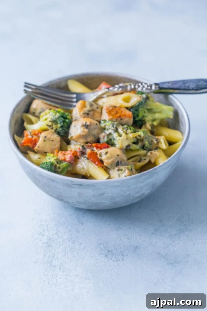 Creamy chicken and broccoli alfredo in  bowl with a fork