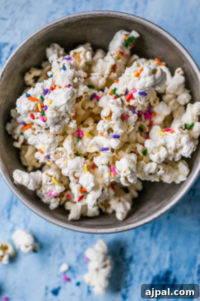 Birthday Cake Popcorn 4 A large serving bowl filled with a generous amount of cake batter white chocolate popcorn, showcasing its colorful sprinkles.