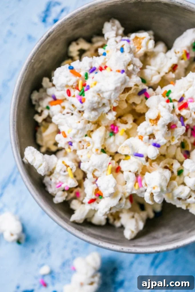 Birthday Cake Popcorn 5 A mixing bowl filled with creamy white chocolate and cake batter mixture, ready to coat the popcorn.