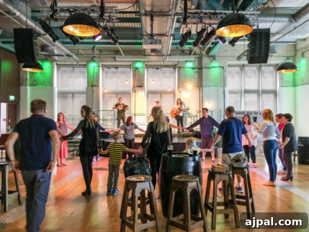 Dublin Awaits Top Reasons and Essential Experiences 25 A young boy dancing an Irish jig with performers at the Guinness Storehouse, showcasing the family-friendly atmosphere.