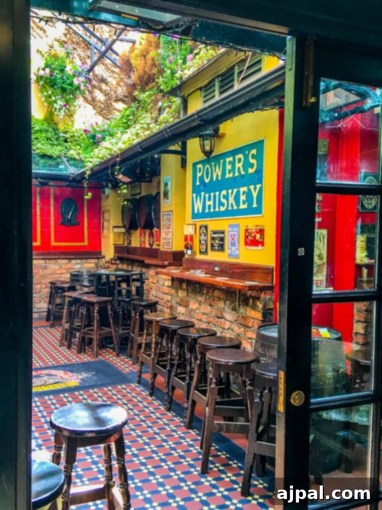 Dublin Awaits Top Reasons and Essential Experiences 29 A charming street in Temple Bar, Dublin, adorned with colorful flowers and traditional pub signage.