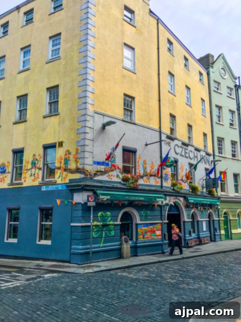 Dublin Awaits Top Reasons and Essential Experiences 6 A quaint traditional Irish pub in Temple Bar, Dublin, with a vibrant red facade and inviting atmosphere.