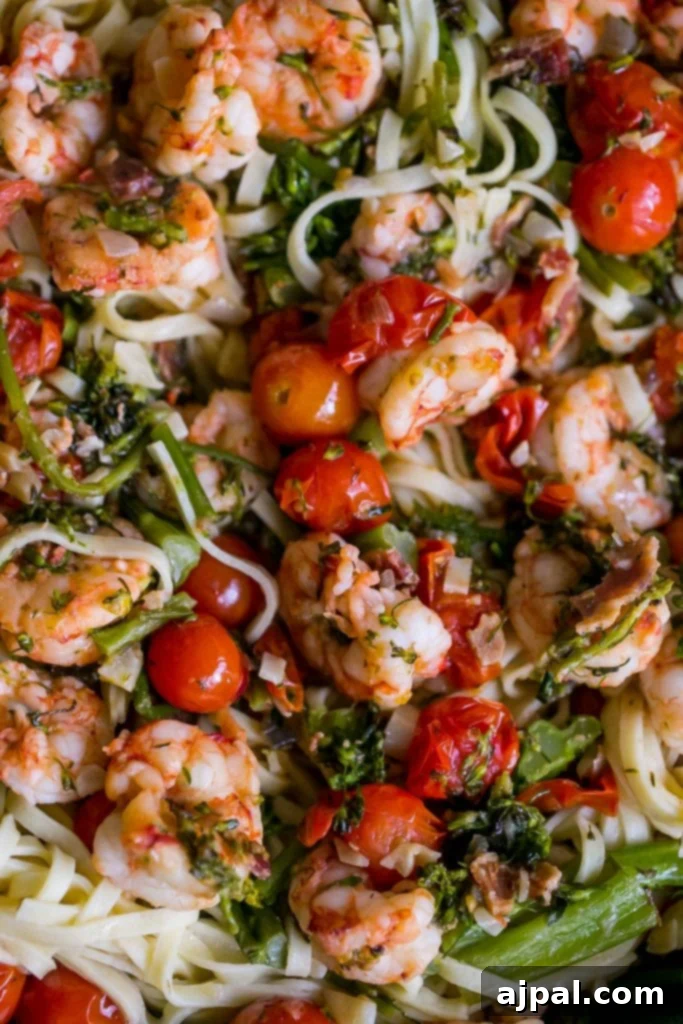 Tuscan Shrimp Linguine, a creamy pasta dish with shrimp, tomatoes, and broccoli.
