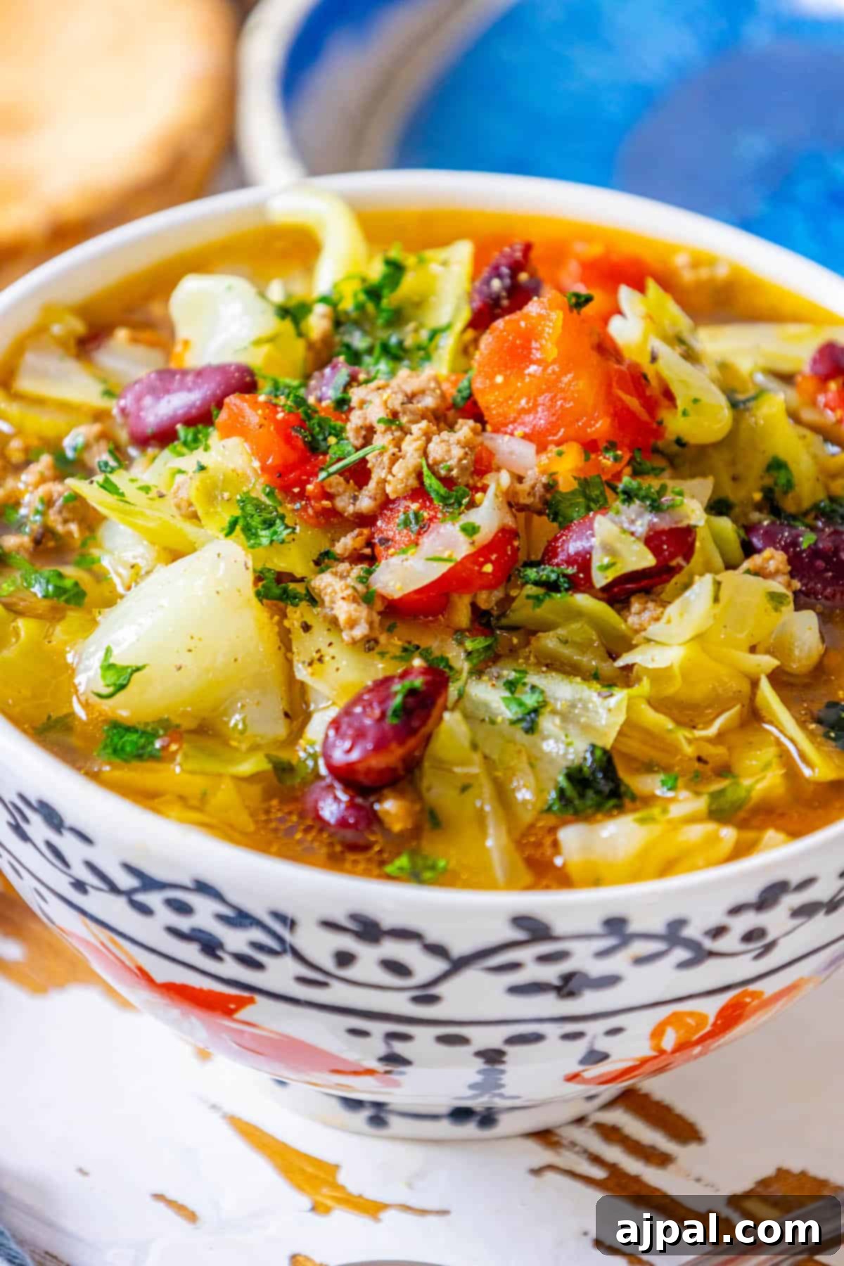 A steaming bowl of comforting cabbage soup with ground beef and tender vegetables, ready to be enjoyed.
