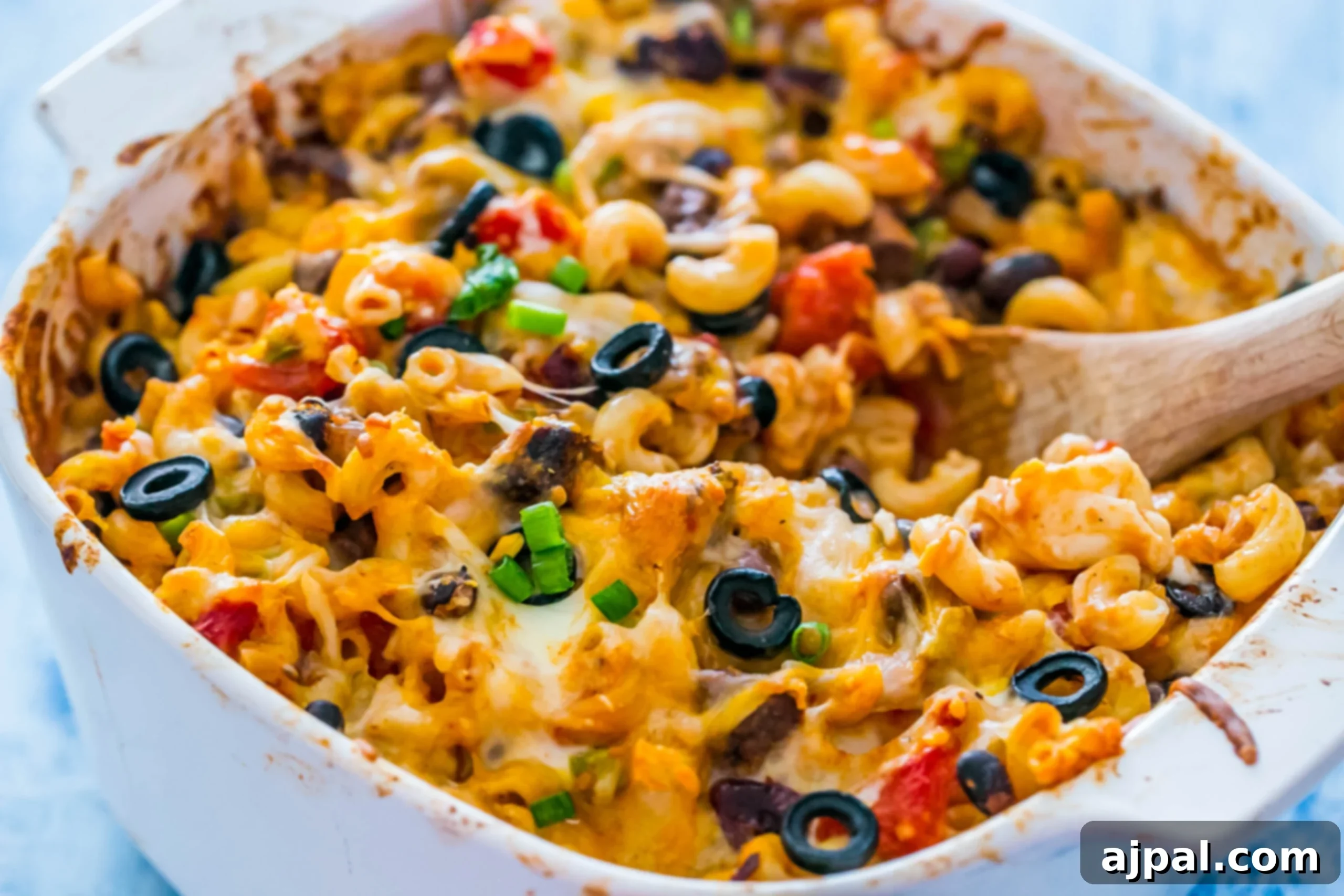 A serving of Cheesy Taco Pasta Bake scooped onto a plate, showing the rich texture, melted cheese, and hearty ingredients ready to be enjoyed.