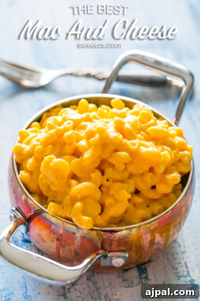 A bowl of creamy mac and cheese garnished with fresh parsley.