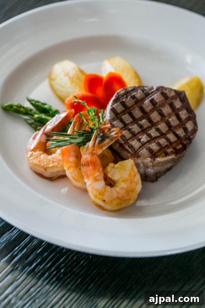 perfectly cooked steak and shrimp with asparagus and carrots