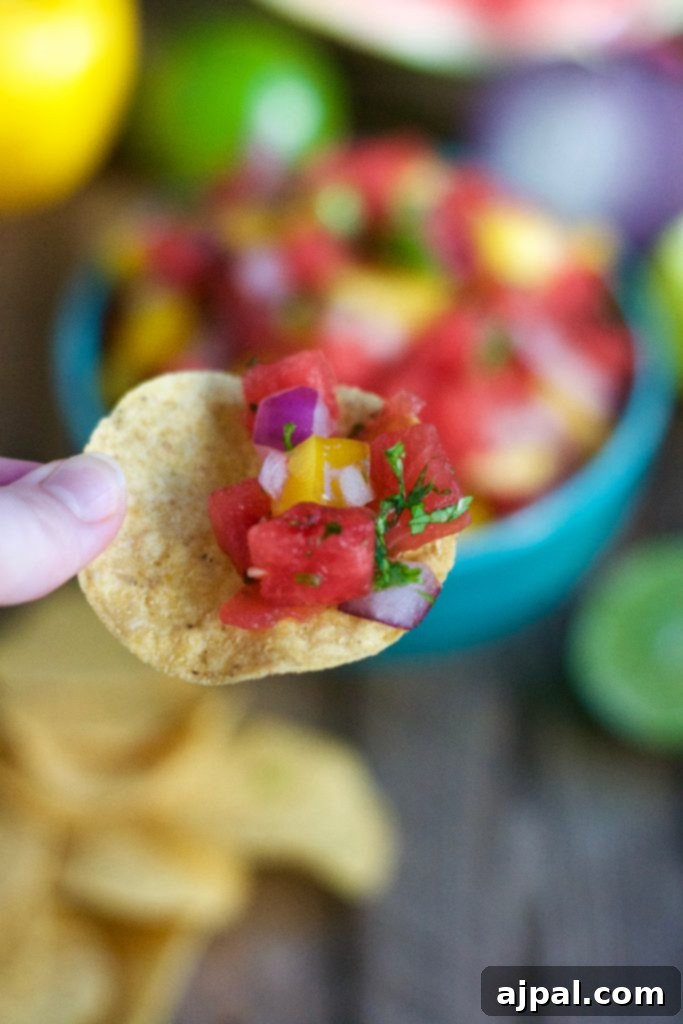 Refreshing Watermelon Salsa 5 Watermelon salsa served in a blue bowl with a tortilla chip.
