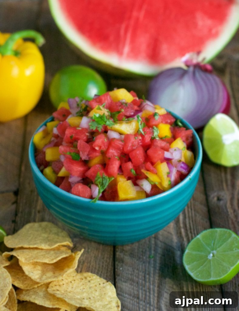 Refreshing Watermelon Salsa 6 Watermelon salsa in a blue bowl, garnished with fresh herbs.