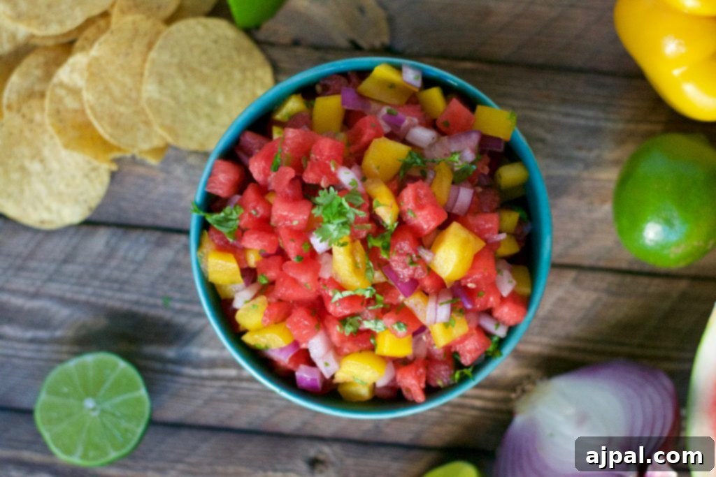 Refreshing Watermelon Salsa 4 Close-up of watermelon salsa scooped onto a tortilla chip.