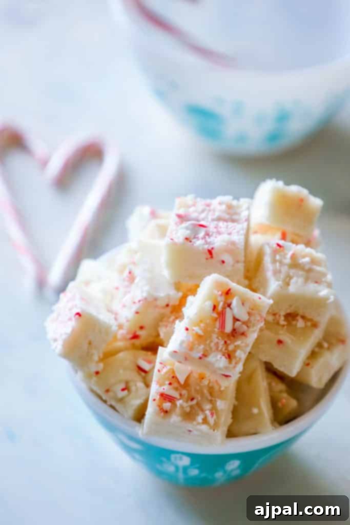An array of delicious cake batter candy cane fudge pieces, artfully arranged, perfect for gifting during the holidays.