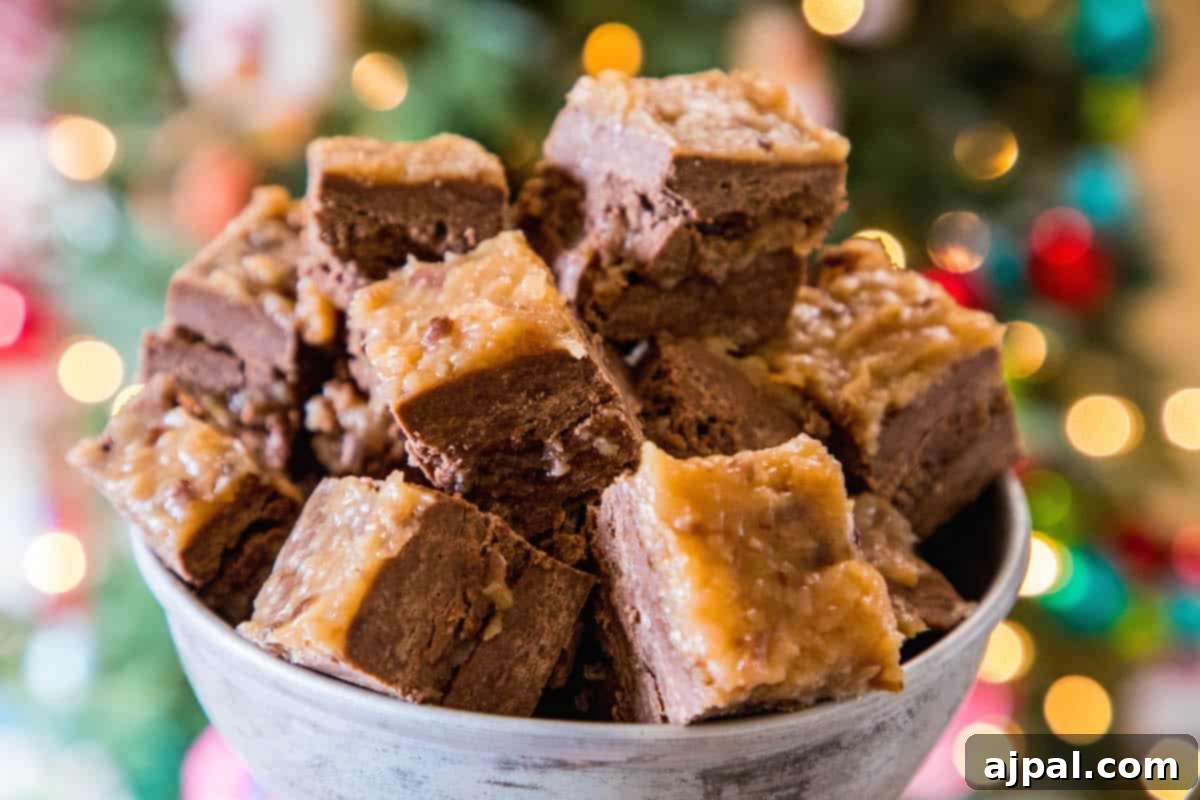 A charming bowl of German chocolate fudge pieces set against a festive, blurred Christmas tree backdrop.