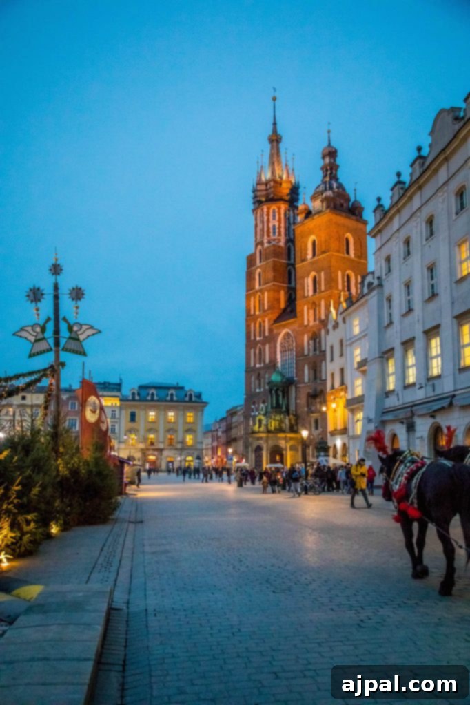 Horse-drawn carriage passing through the festive Krakow Christmas Market in Poland.