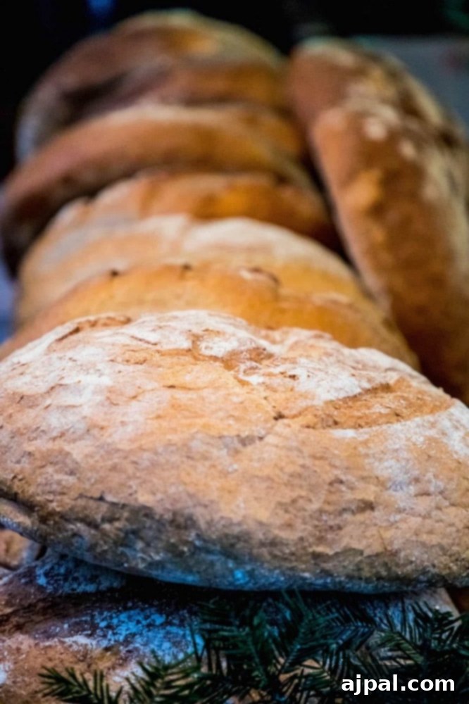 Many loaves of bread are lined up on a table at the Krakow Christmas Market.