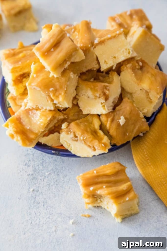 Decadent Dulce De Leche Cake Batter Fudge 2 creamy caramel colored fudge stacked on a plate