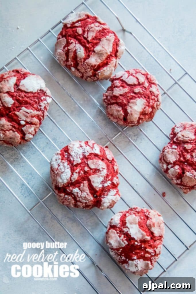Soft and delicious Red Velvet Crinkle Cookies cooling on a wire rack.