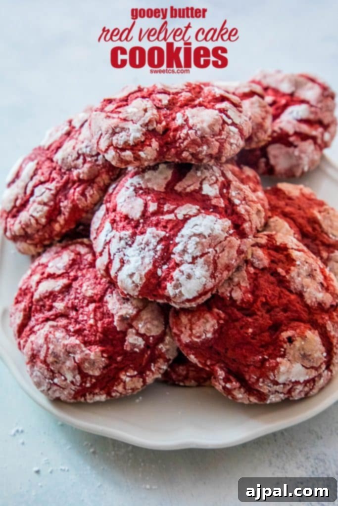 A stack of perfectly baked Red Velvet Cake Cookies, showing their soft centers and crinkled tops.